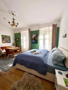a bedroom with a bed and a dining room at Schlafen im historischen Haus in Weier