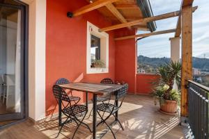 a patio with a wooden table and chairs on a balcony at Cinque terre - Laspezia - Loft 1910 in La Spezia