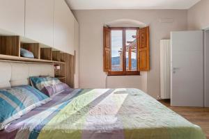 a bedroom with a large bed and a window at Cinque terre - Laspezia - Loft 1910 in La Spezia