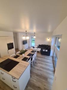 a kitchen and living room with a long table at Emily in Geeste