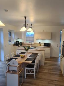 a kitchen with a large wooden table and chairs at Emily in Geeste