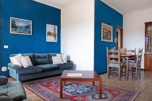 a blue living room with a couch and a table at Home Pier in Laveno-Mombello