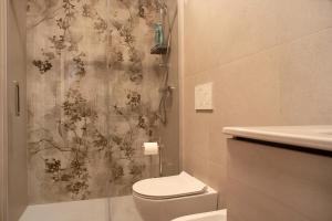 a bathroom with a toilet and a shower at Home Pier in Laveno-Mombello +15 photos