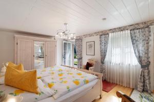 a bedroom with a bed and a chandelier at Haus Haag Enzklösterle in Enzklösterle