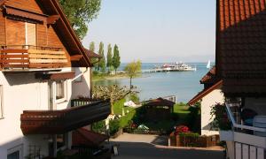 a view of the water from between two buildings at Sommerhof Rauber in Immenstaad am Bodensee