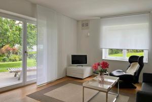 a living room with a tv and a table at Ferienwohnung Peterberg 22, 45qm in Kirchzarten