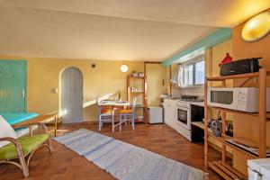 a living room with a kitchen and a dining room at Studio vue sur mer in Plomodiern
