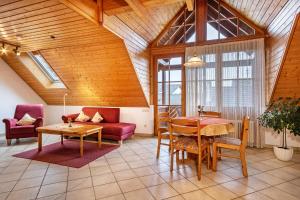 a living room with a couch and a table at Ferienhaus Behler in Kressbronn am Bodensee
