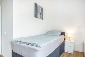 a small bedroom with a bed and a night stand at Kleine Himmelpforte in Himmelpforten