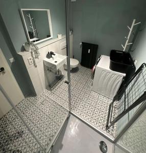 a bathroom with a toilet and a sink and a mirror at Chiemsee Schwanenloft in Seebruck