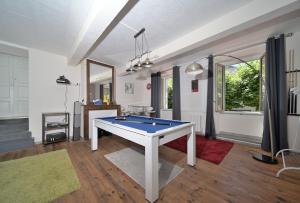 a living room with a pool table in it at Chambre Verte in Auzat