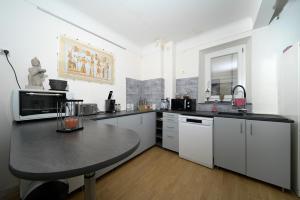 a kitchen with a table in the middle of it at Chambre Verte in Auzat