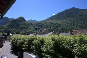 a view of a village with mountains in the background at Chambre Verte in Auzat