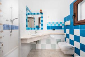a bathroom with a sink and a toilet at Villa Pedduzza in Orosei +27 photos