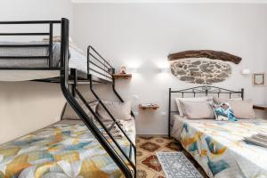 a bedroom with two bunk beds in a room at Gustalu in Dorgali