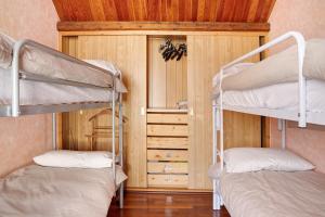 two bunk beds in a room with a wooden ceiling at In Valtellina da Valter e Lella in Colorina