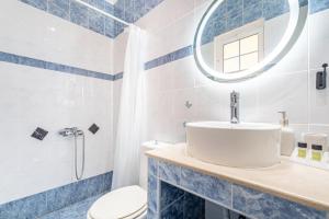 a bathroom with a sink and a toilet and a mirror at Spyridoula Studio 4 in Paleokastritsa +16 photos