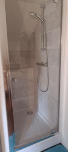 a shower with a glass door in a bathroom at Chambres D'hôtes Les Préaux - in Cérans-Foulletourte +20 photos