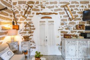 a living room with a stone wall at Tipica casa a San Pantaleo in San Pantaleo