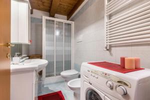 a white washer and dryer in a bathroom at Casa Giuly in Mirano +15 photos