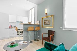 a living room with a couch and a table at Chalet au bord de l'eau in Fréjus
