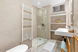 a bathroom with a shower and a toilet and a sink at Chalet au bord de l'eau in Fréjus +16 photos
