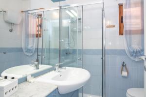 a bathroom with a sink and a glass shower at Villa Clelia in Palau