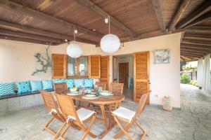 a dining room with a wooden table and chairs at Villa Clelia in Palau +12 photos