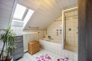 a attic bathroom with a shower and a tub at Elli in Aulendorf