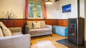 a living room with a couch and a chair at Das Schneiderhaus in Höchenschwand