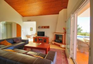 a living room with a couch and a fireplace at Luxurius Villa with private pool in Mijas