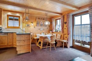 a kitchen and dining room with a table and chairs at Ferienwohnung Huttenberg in Reit im Winkl