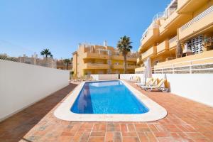 a swimming pool in front of a building at Royal Cabanas Golf 87 in Cabanas de Tavira