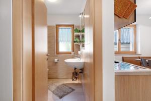 a bathroom with a sink and a toilet in a room at Innerjerberhof Neiderseit in Lauregno