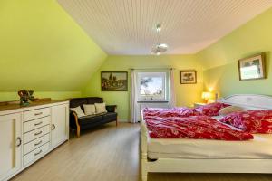 a bedroom with a bed with red pillows at Ferienhaus Busch in Elpersbüttel