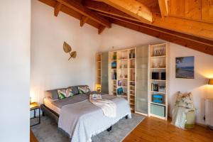 a bedroom with a bed and a book shelf at Ferienwohnung Breitenberger in Herrsching am Ammersee