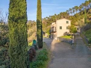 a row of trees in front of a building at Casa Max in Levanto