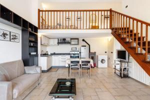a living room with a couch and a table at Casa Max in Levanto +17 photos