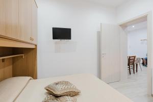 a bedroom with a bed with a pillow on it at Casa Vacanza Iris Castelvetrano in Castelvetrano Selinunte