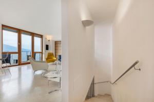 a living room with a table and chairs at Ca dela Nua front lake in Limone sul Garda +101 photos