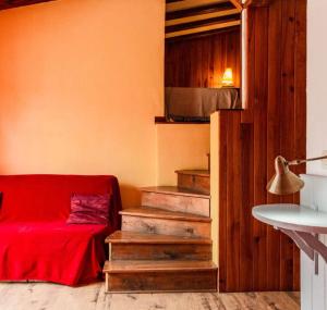 a room with a red bed and stairs in it at Les Planious in LʼÉpine +72 photos