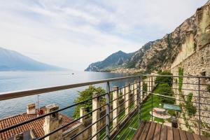 a balcony with a view of the water and mountains at Ca dela Nua front lake in Limone sul Garda