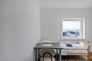 a bedroom with a table and a bed with a window at Haus Fuldablick in Rotenburg an der Fulda +114 photos