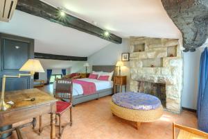 a bedroom with a bed and a fireplace at Le Grimaldi in Cagnes-sur-Mer