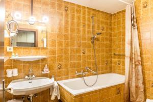 a bathroom with a tub and a sink and a shower at Haus Excelsior Top 31 in Seefeld in Tirol +17 photos