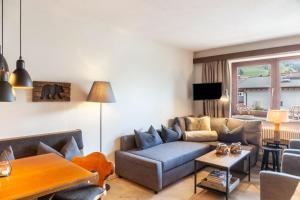 a living room with a couch and a table at Haus Excelsior Top 31 in Seefeld in Tirol