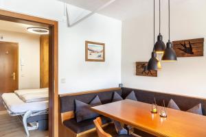 a dining room with a table and a bed at Haus Excelsior Top 31 in Seefeld in Tirol