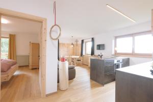 a kitchen and living room with a kitchen and a living room at Ferienwohnung Berg Wieserhof in Aldino