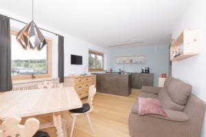 a kitchen and living room with a table and a couch at Ferienwohnung Berg Wieserhof in Aldino