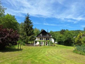 a house on a hill with a large yard at Haus Annenberg in Monzelfeld